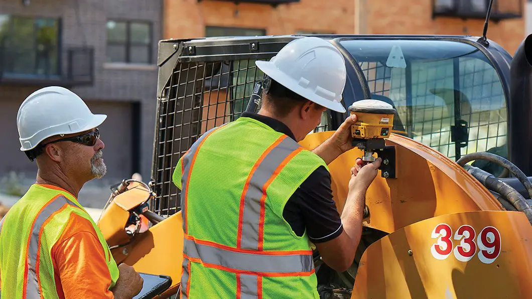 construction workers fitting sensor